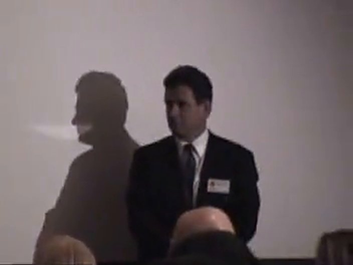 Tim Bolen standing near the stage during Clark's talk